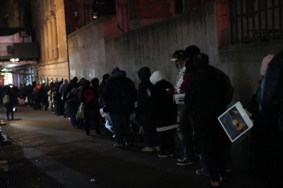 　　12月17日，在美国纽约曼哈顿的一处救助点，人们排队等待领取免费晚餐。新华社记者张凤国摄