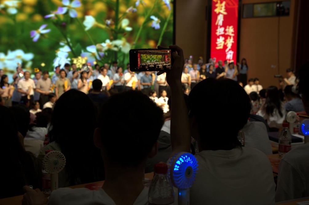 台下毕业生用手机记录毕业这一刻。